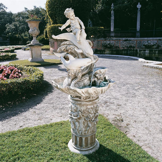 boy riding dolphins water fountain statue